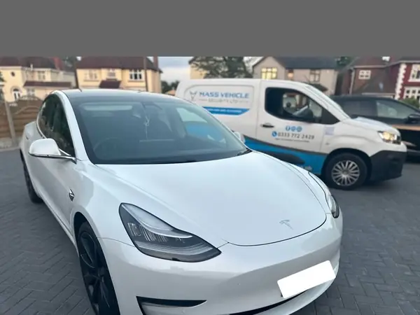 Tesla Model 3 alongside the Mass Vehicle Security installation van